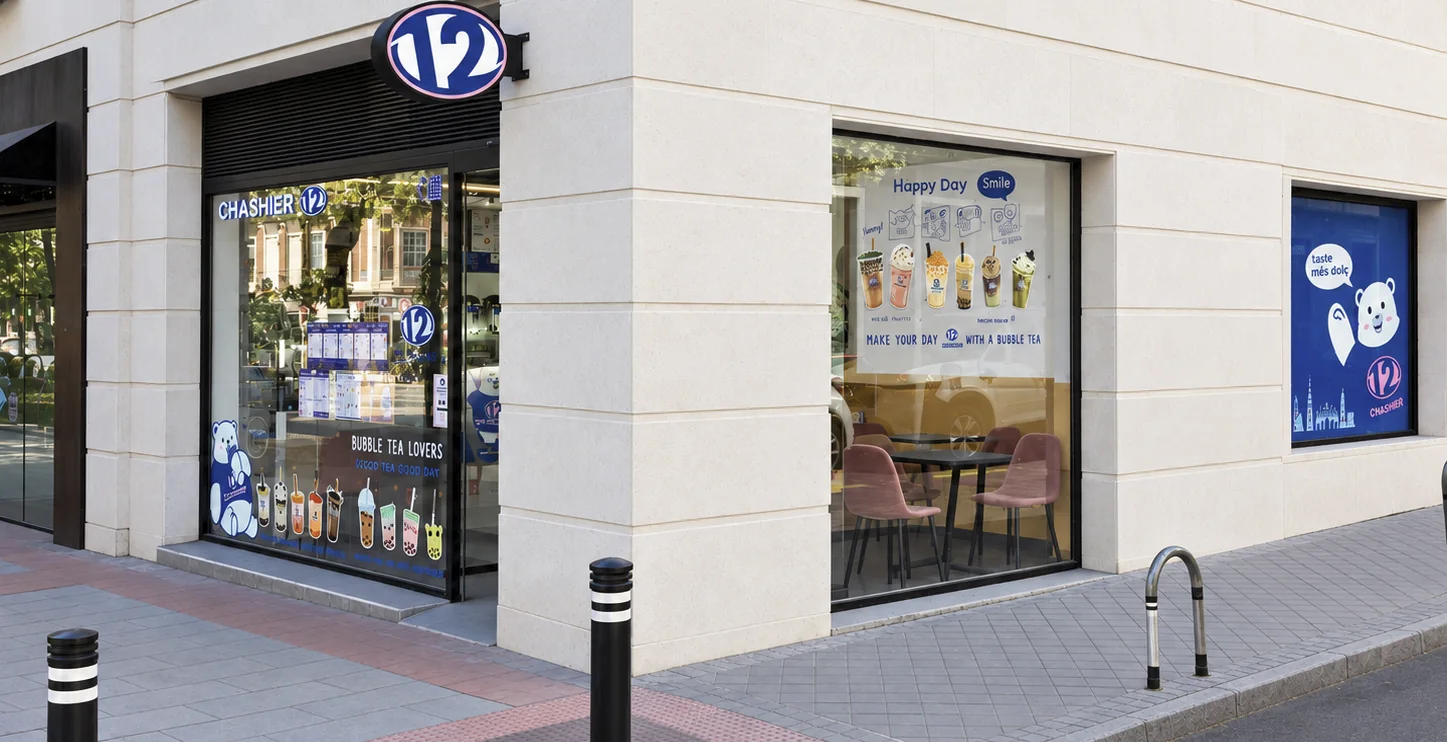 Fachada de la tienda Chashier en Chamberí, Madrid, con el rótulo del 12 sobre la entrada y el escaparate decorado con bubble teas.